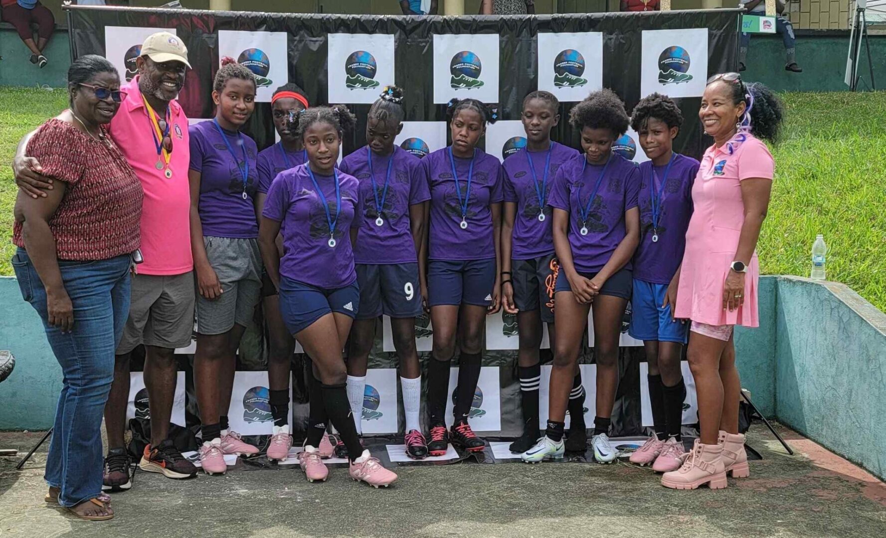 A group of girls in purple shirts and shorts.