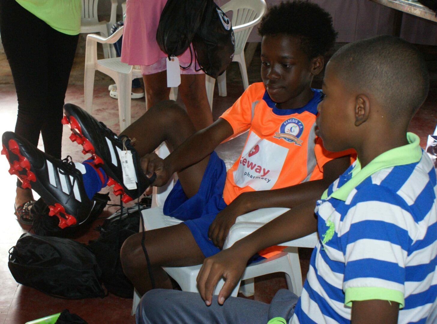 Two young boys playing a video game together.