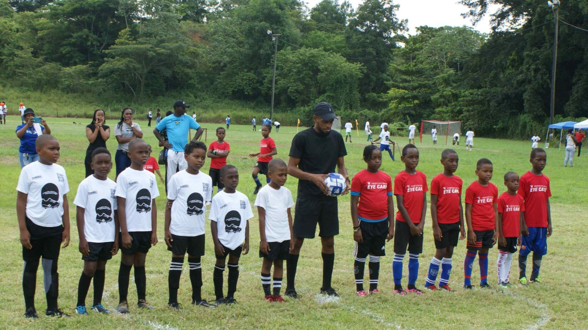 A group of young children standing on top of a field.