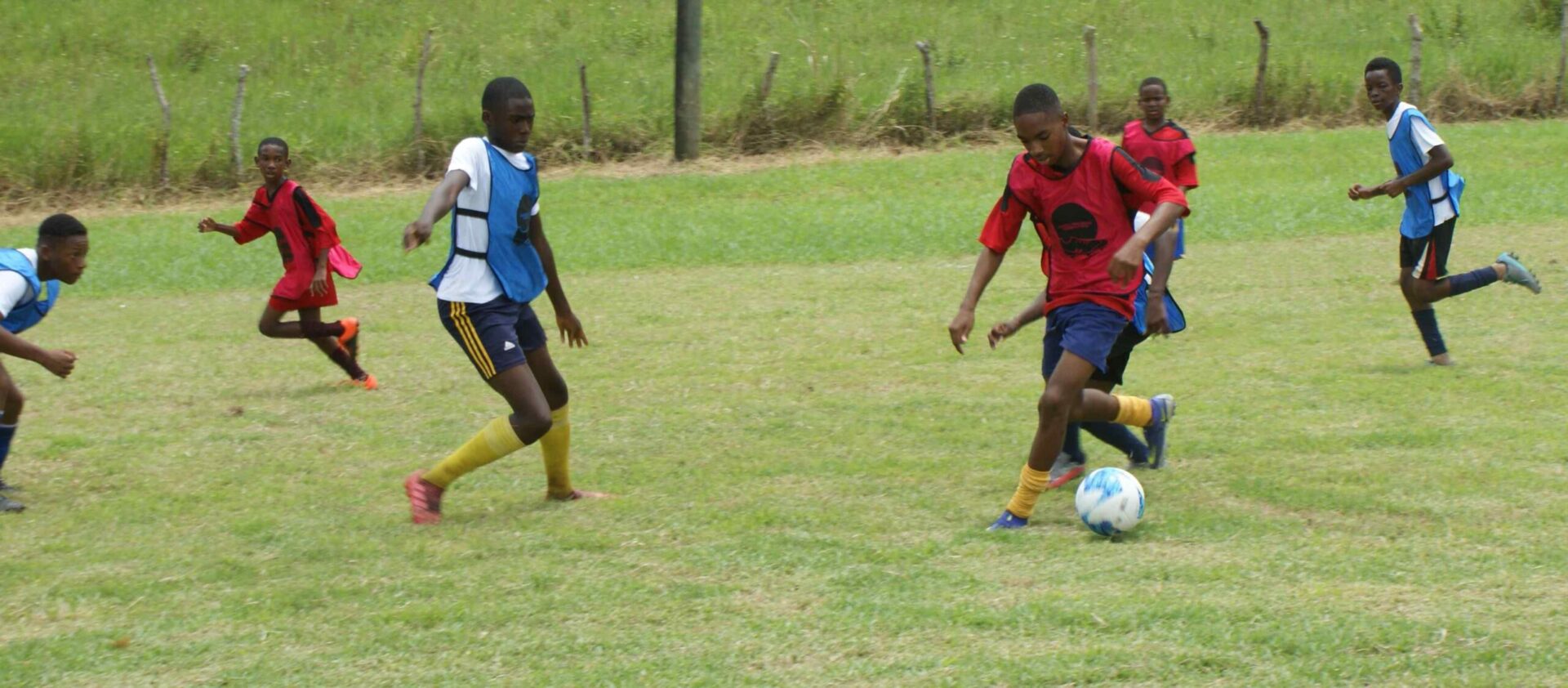 A group of young men playing soccer on a field.