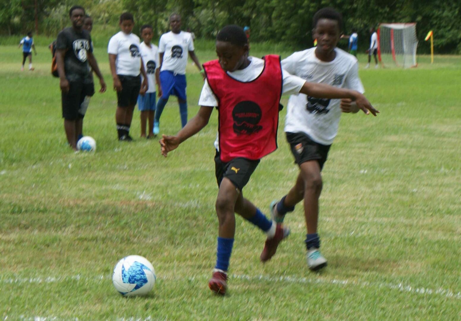 A group of young men playing soccer on the field.