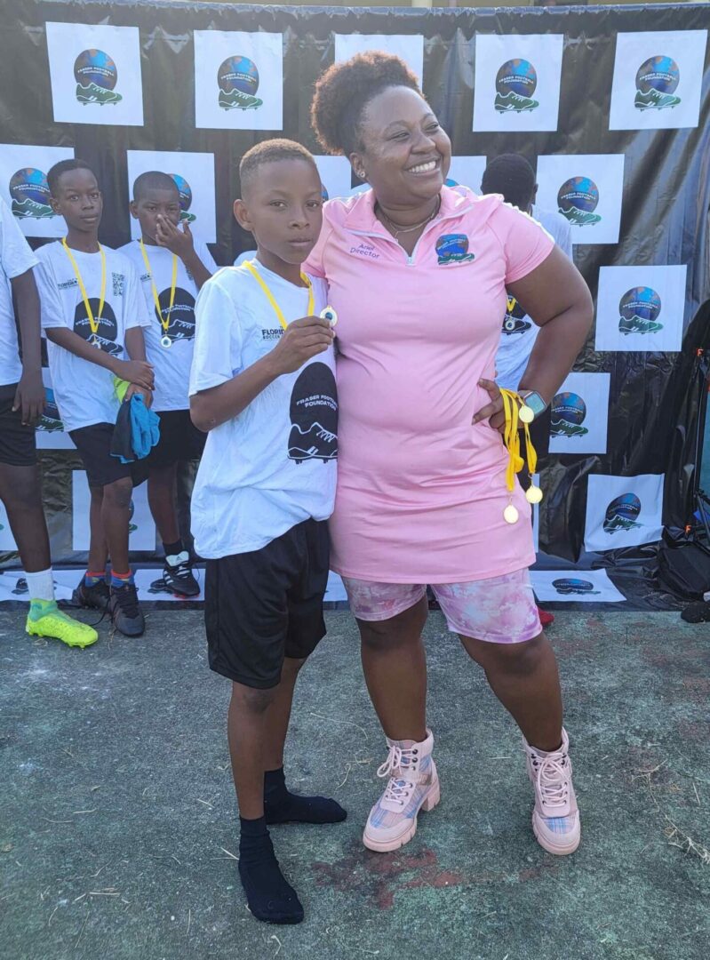 Two people posing for a picture in front of a crowd.